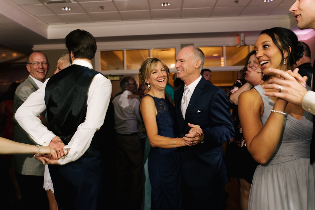mother and father of groom dance at reception