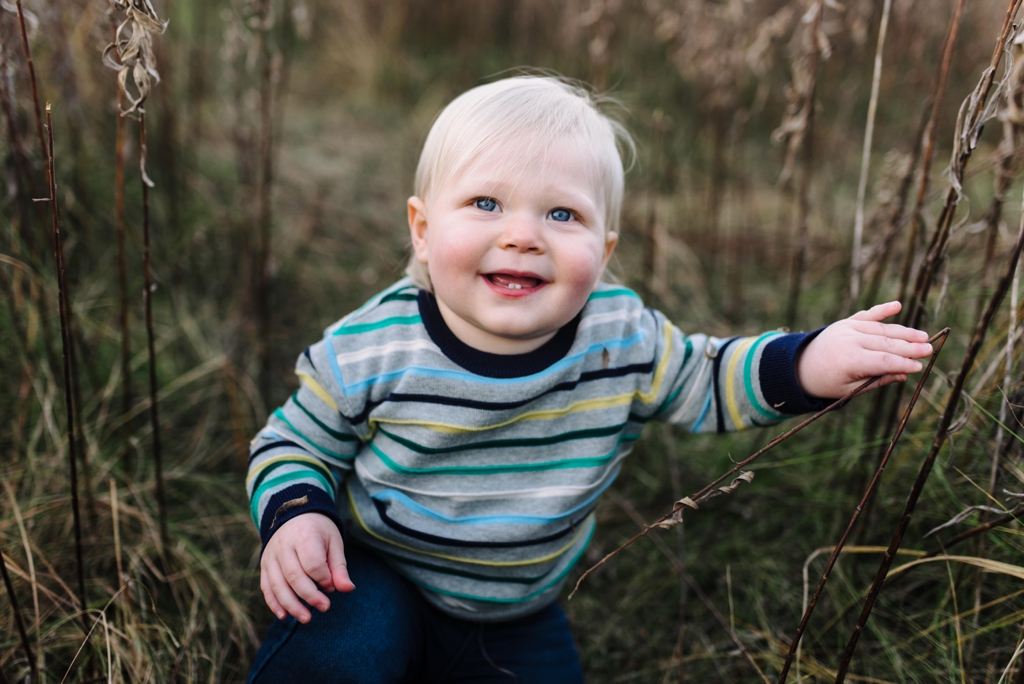 toddler smiling at fall family session in minneapolis
