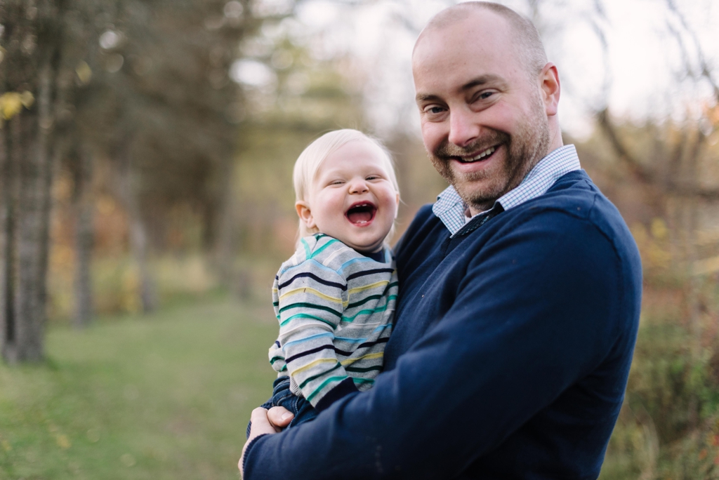 toddler laughing with dad at fall minneapolis session