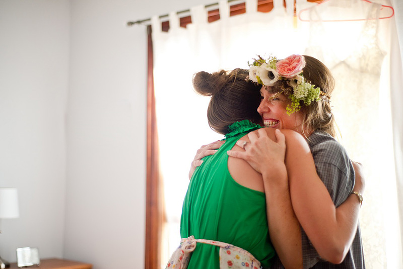 bride to be hugs friend while wearing flower crown