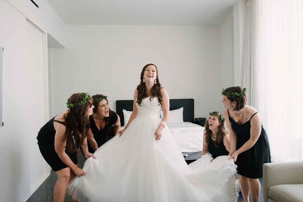 bridesmaids fluffing bride's dress