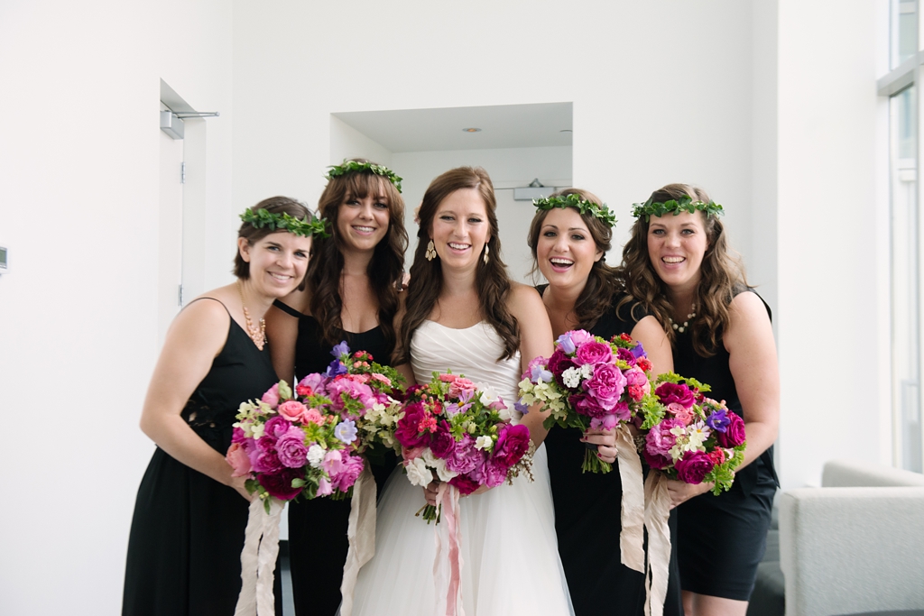 bride and bridesmaids laughing floral wedding