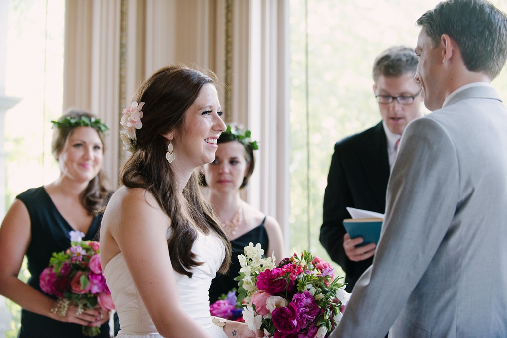 bride smiles at groom during ceremony
