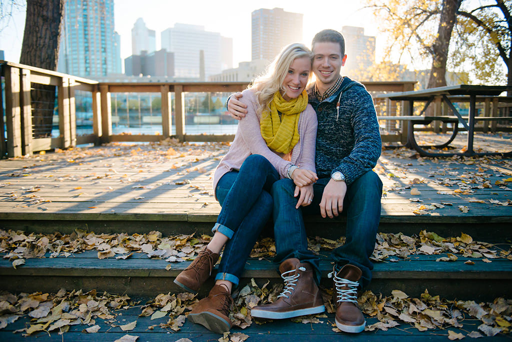 couple sitting on steps of deck by mississippi river