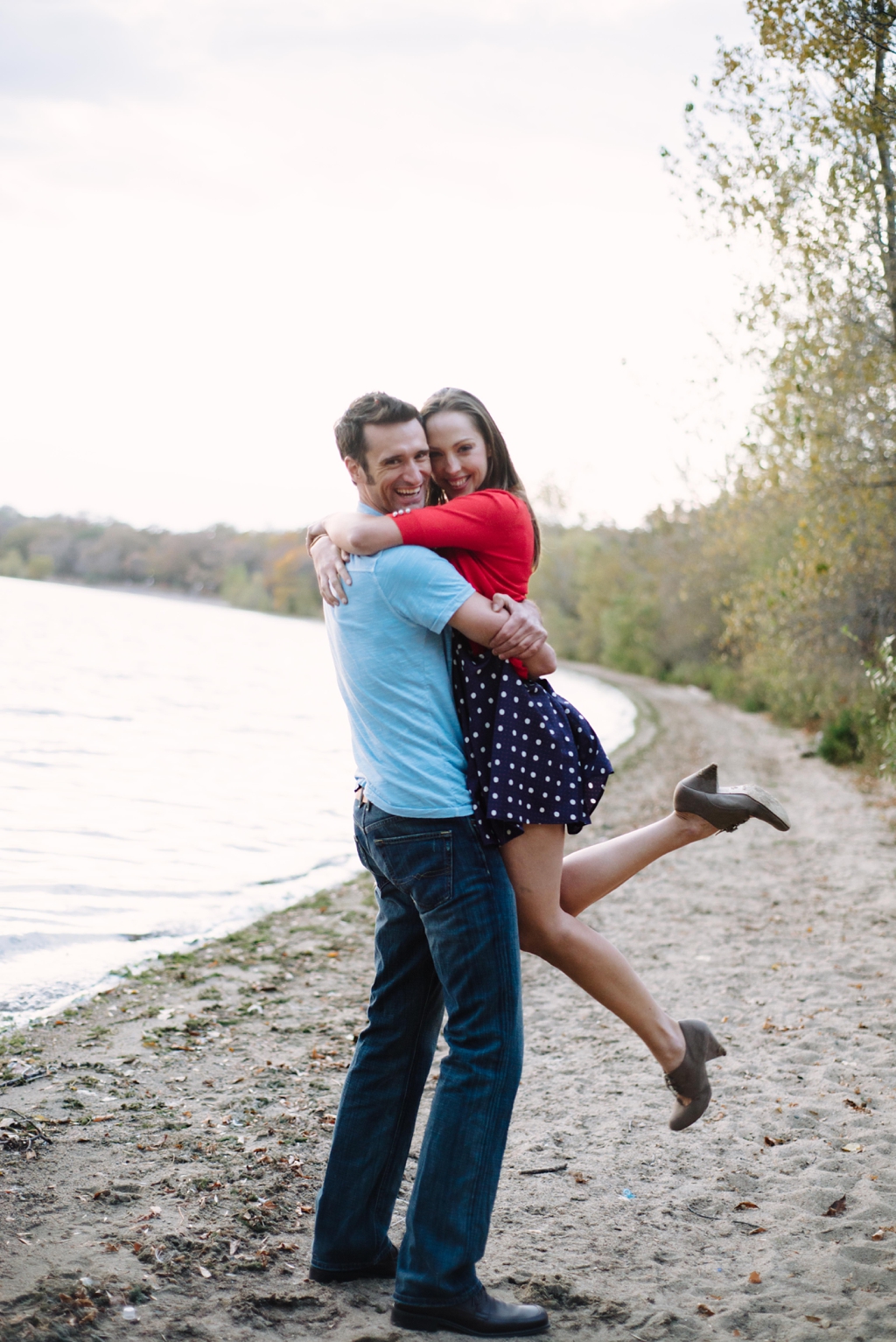 Romantic couple photo jumping lakeside