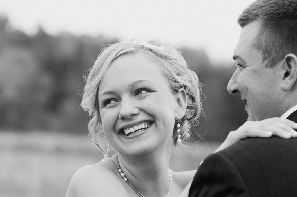 bride smiling in portrait with groom
