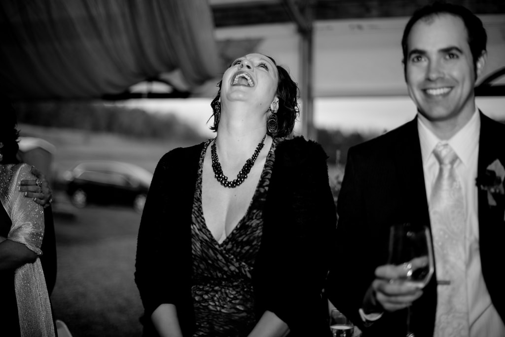 winery wedding guest laughs at speeches during reception
