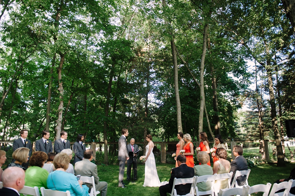 exchanging vows at iowa midwest backyard wedding