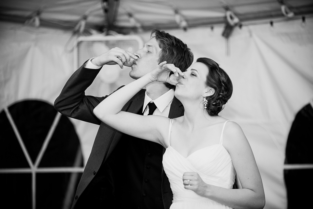 newlyweds take a shot at wedding reception