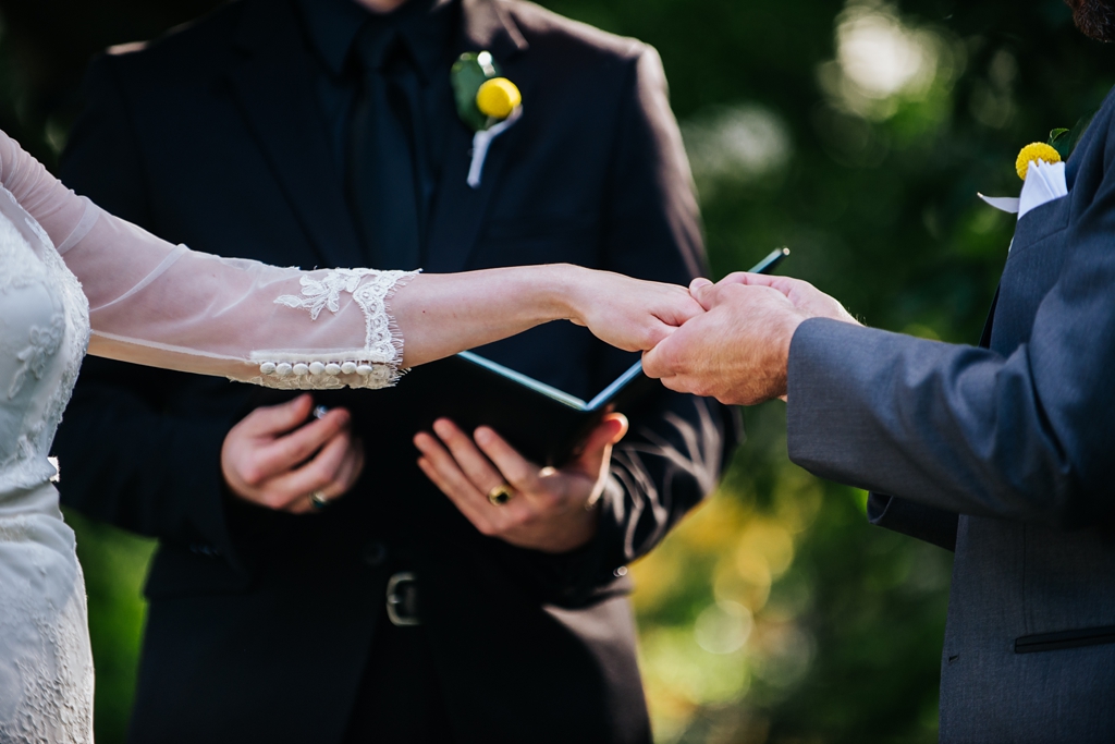 detail of hands during ring exchange at wedding