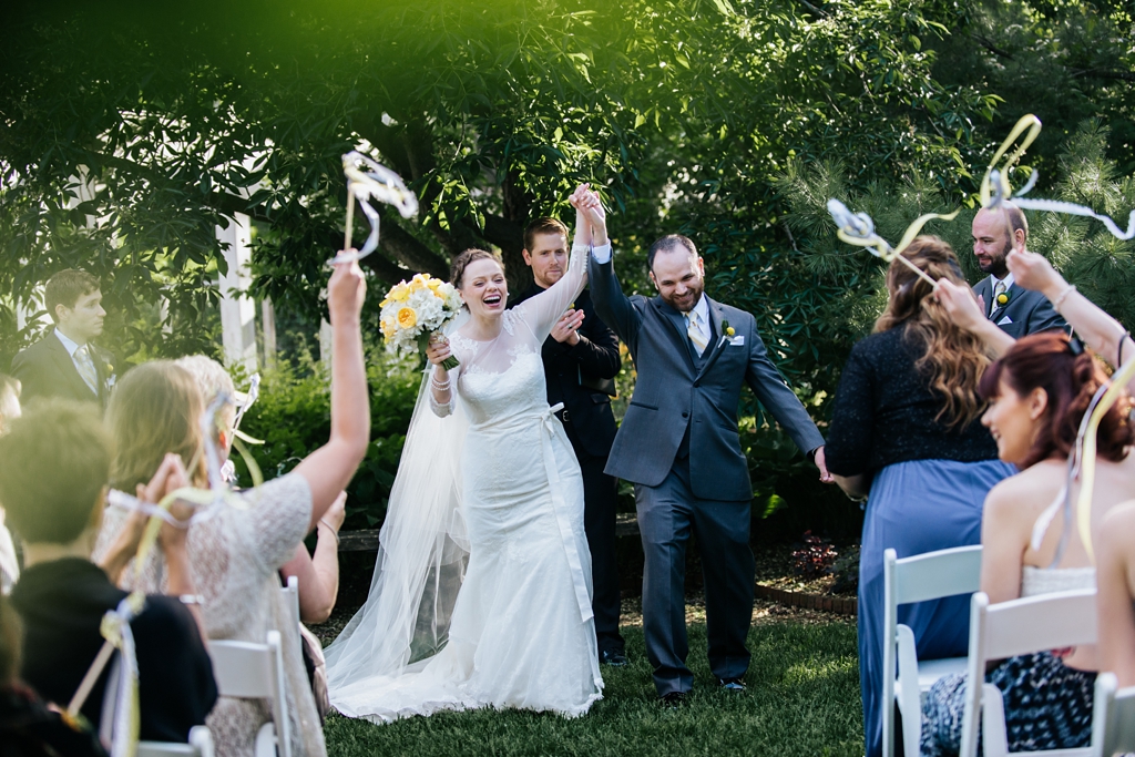 newlyweds celebrate with guests and streamers