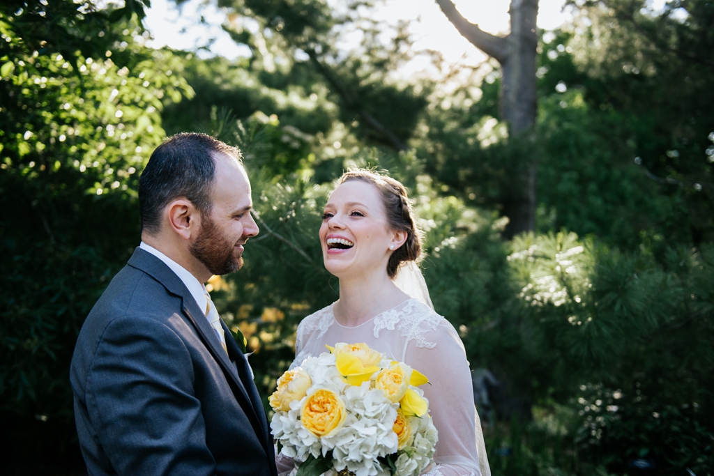 bride laughs during wedding portrait at minnesota arboretum