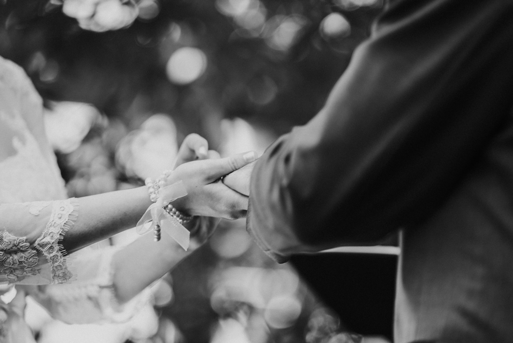 detail of bride and groom exchanging rings