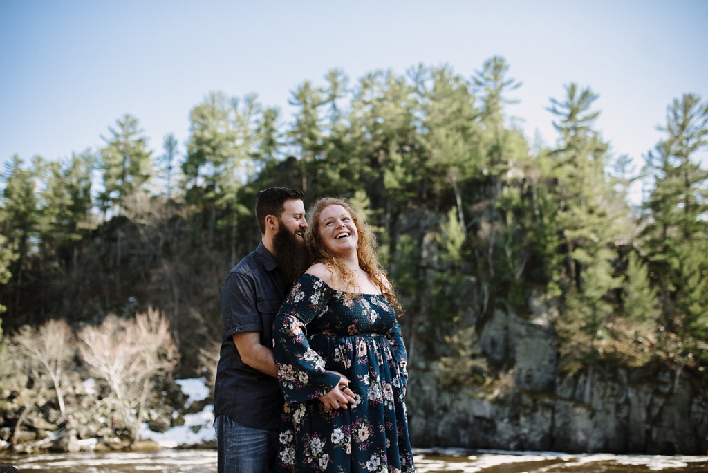 couple laughing at taylor falls minnesota engagement session