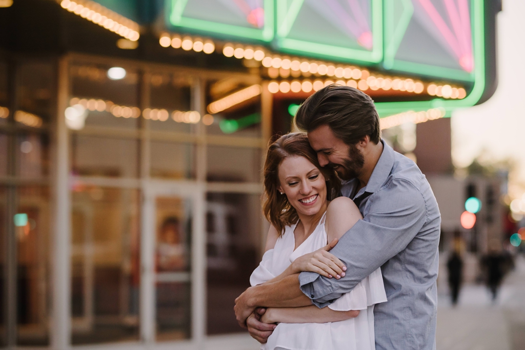 couple in front of movie theater engagement location in Hopkins
