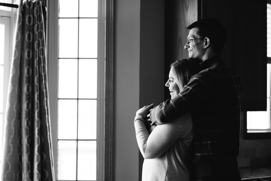 minnesota couple embracing by window in black and white