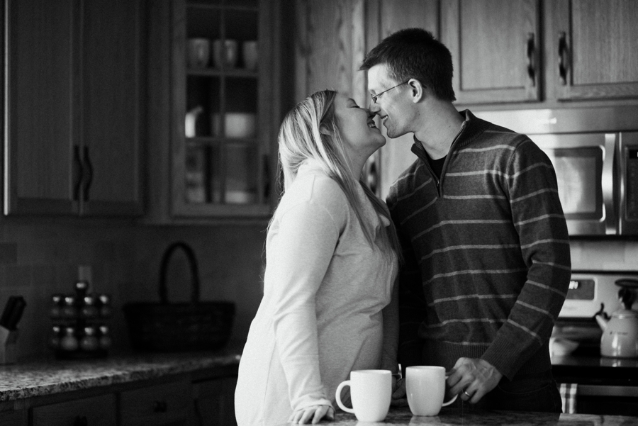 couple kissing in kitchen in twin cities