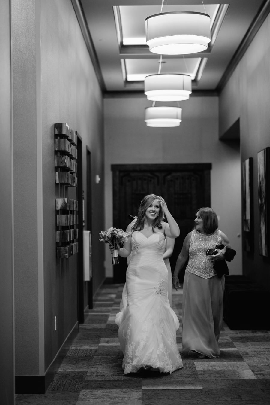 bride walking out from the hotel suite