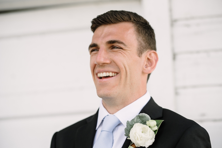 candid portrait of groom smiling