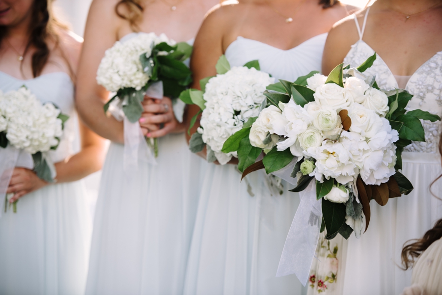 light blue and white bridesmaids dresses and bouquets