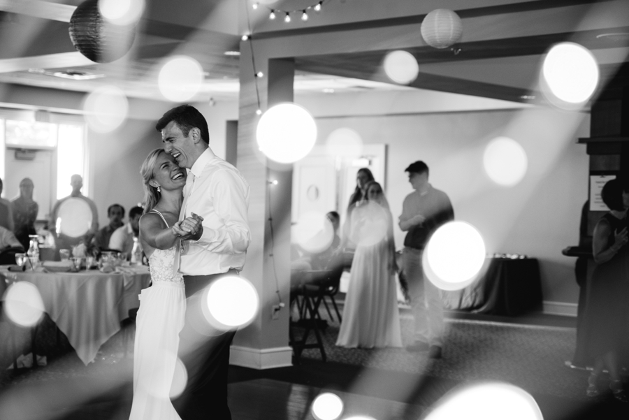 bride and groom first dance photo with adorned lights