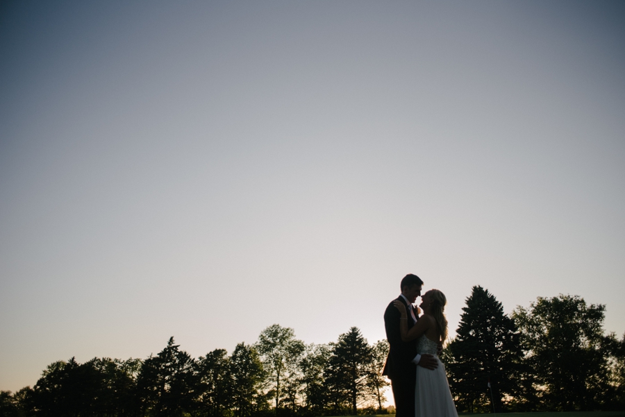 bride and groom silhouette during sunset