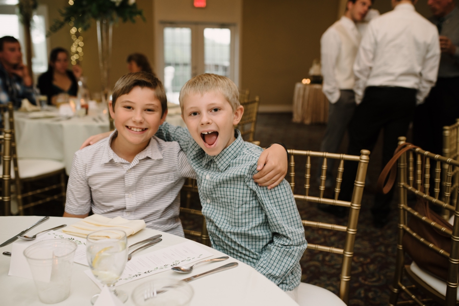 two young boys smiling at reception