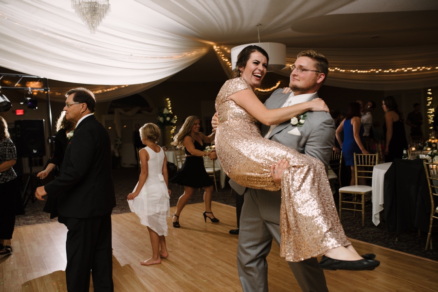 groomsman and bridesmaid dancing at wedding reception 