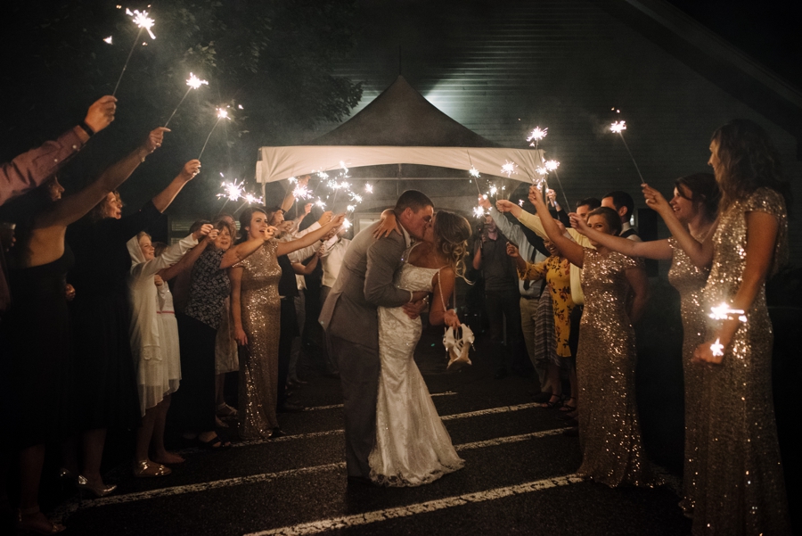 bride and groom leave wisconsin reception with a sparkler tunnel 