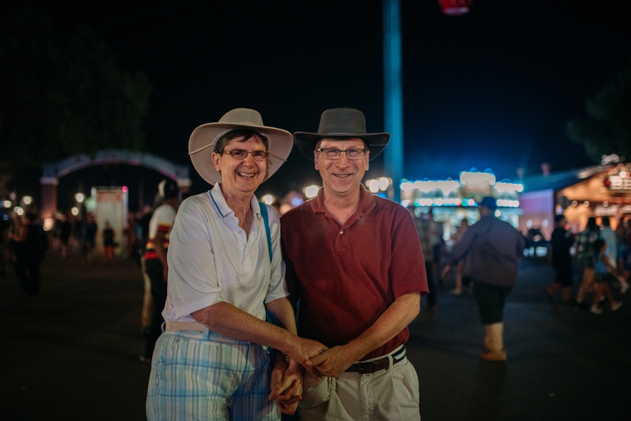 married couple holding hands at nightime during minnesota state fair