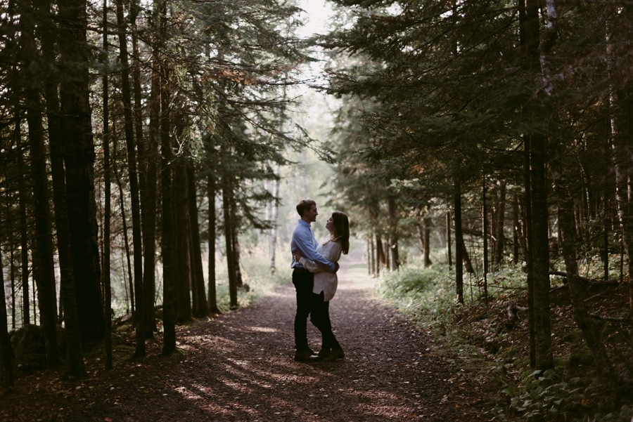 couple gazes into each other's eyes in minnesota woods