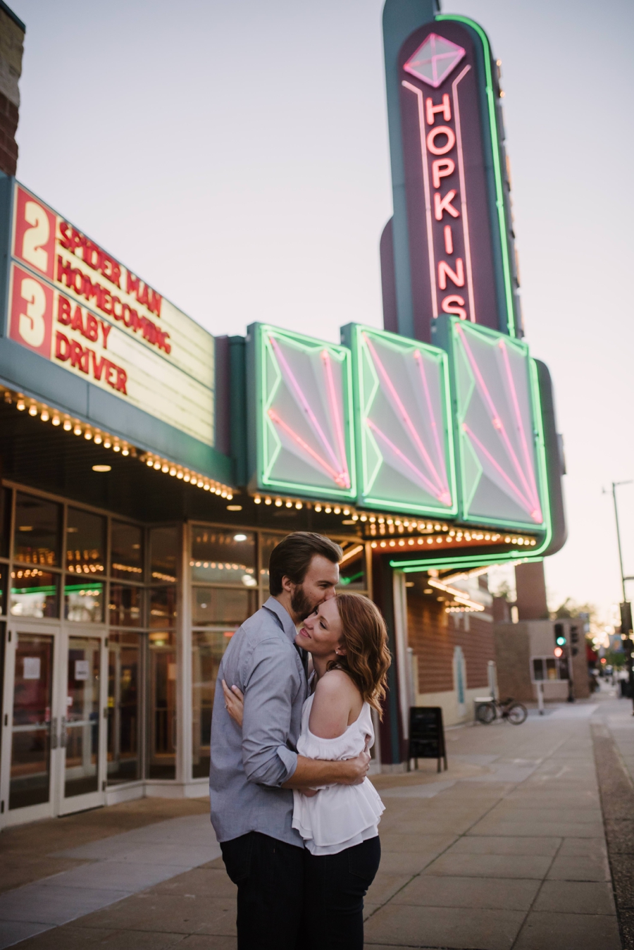 Happy Couple outside Movie theater during engagement session