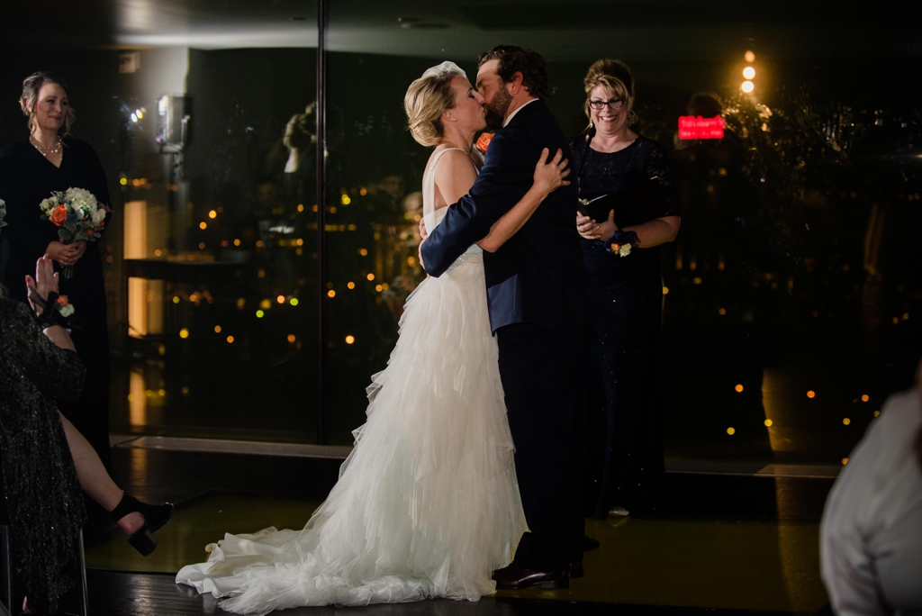 bride and groom first kiss in minneapolis indoor ceremony