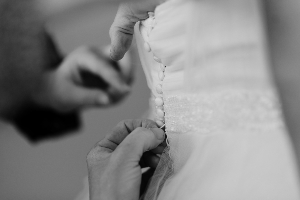 Minnesota Wedding Photographer, Detail of buttoning down bridal dress