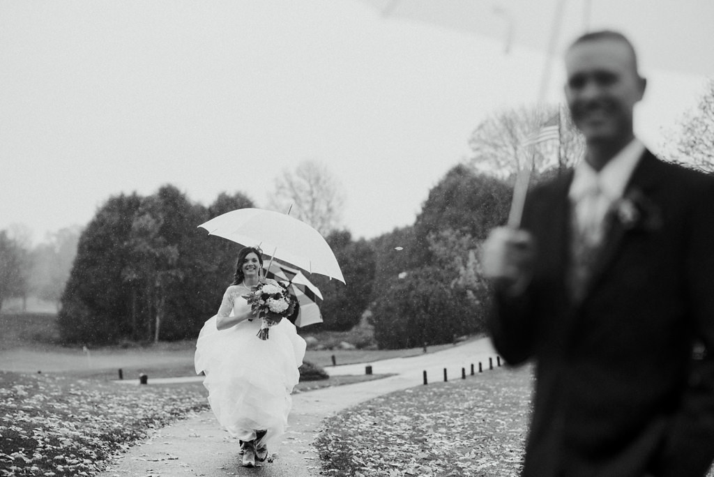 bride and groom first look during Minnesota rainy wedding