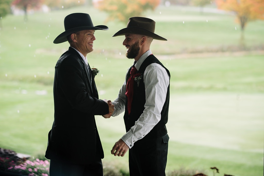 Groom and best man shaking hands before ceremony