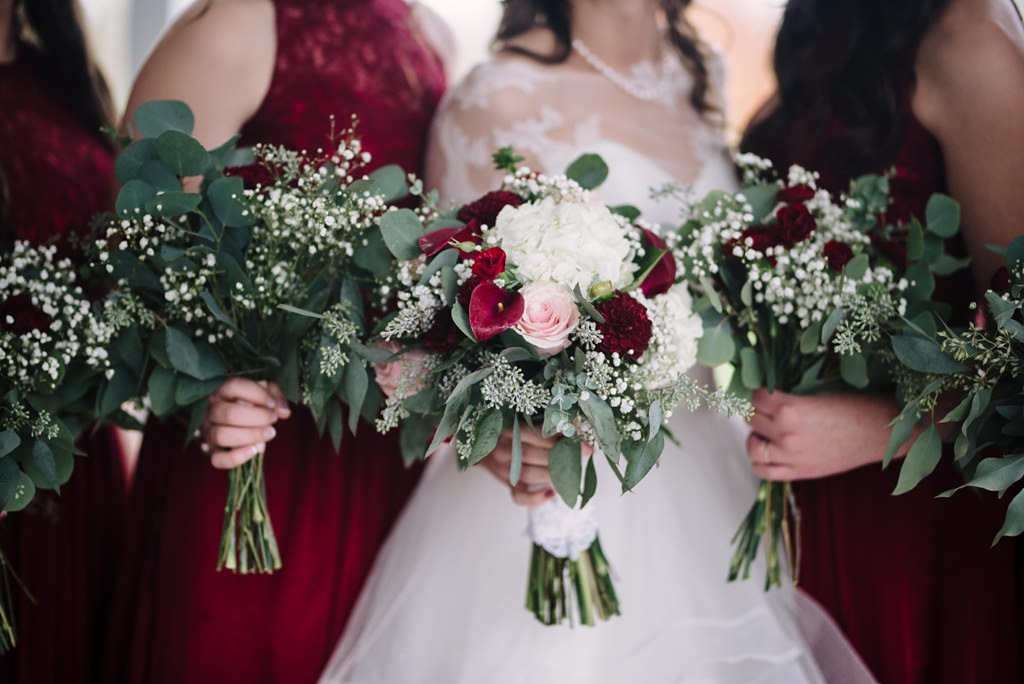 cranberry red bouquets detail shot during MN bridal party photos