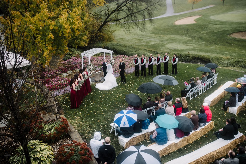 Minnesota outdoor golf course wedding ceremony with umbrellas