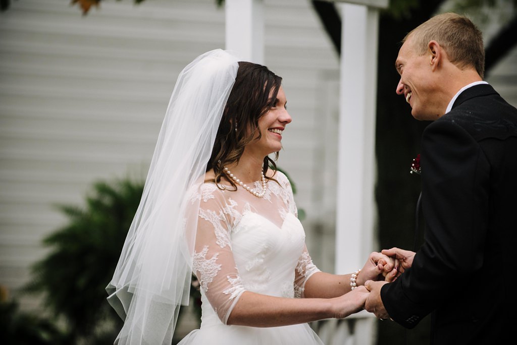 bride and groom laugh happily during MN wedding ceremony outside