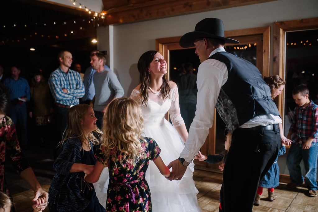 bride and groom dance with flower girls during MN wedding reception