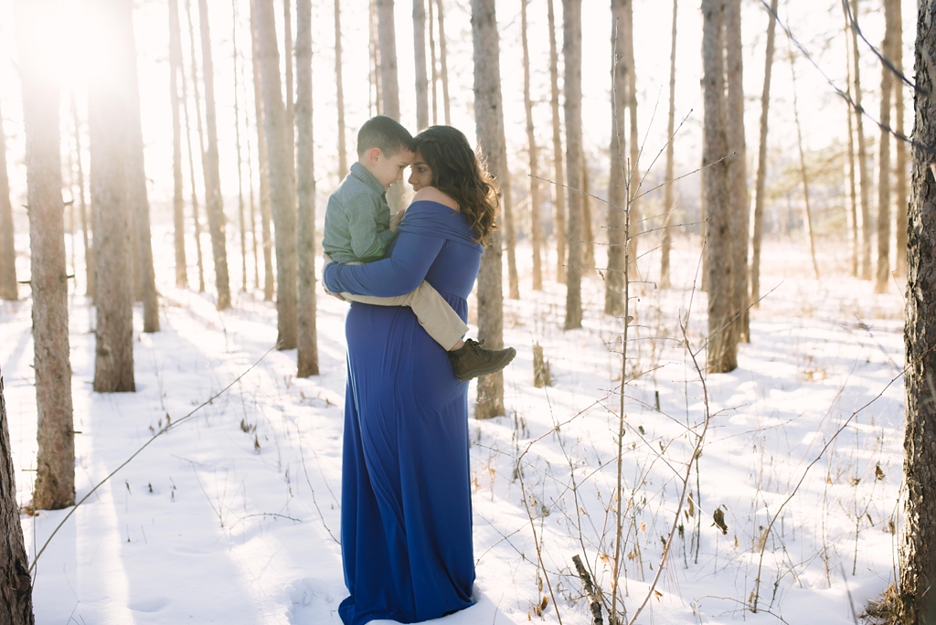 winter maternity session in minnesota woods