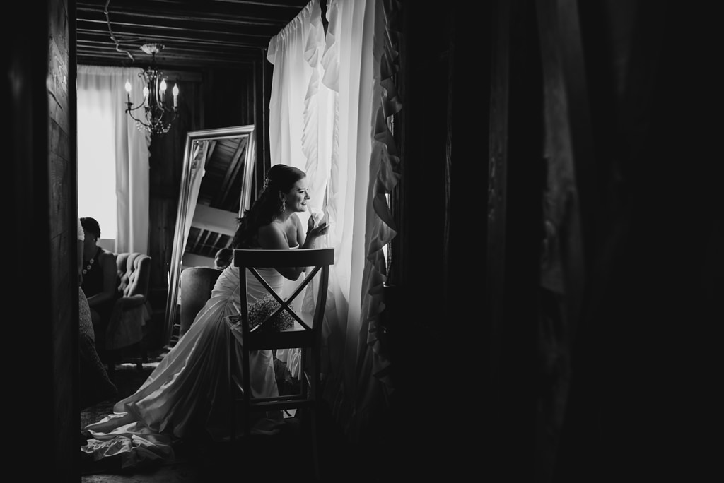Twin cities Bride peeking outside during getting ready