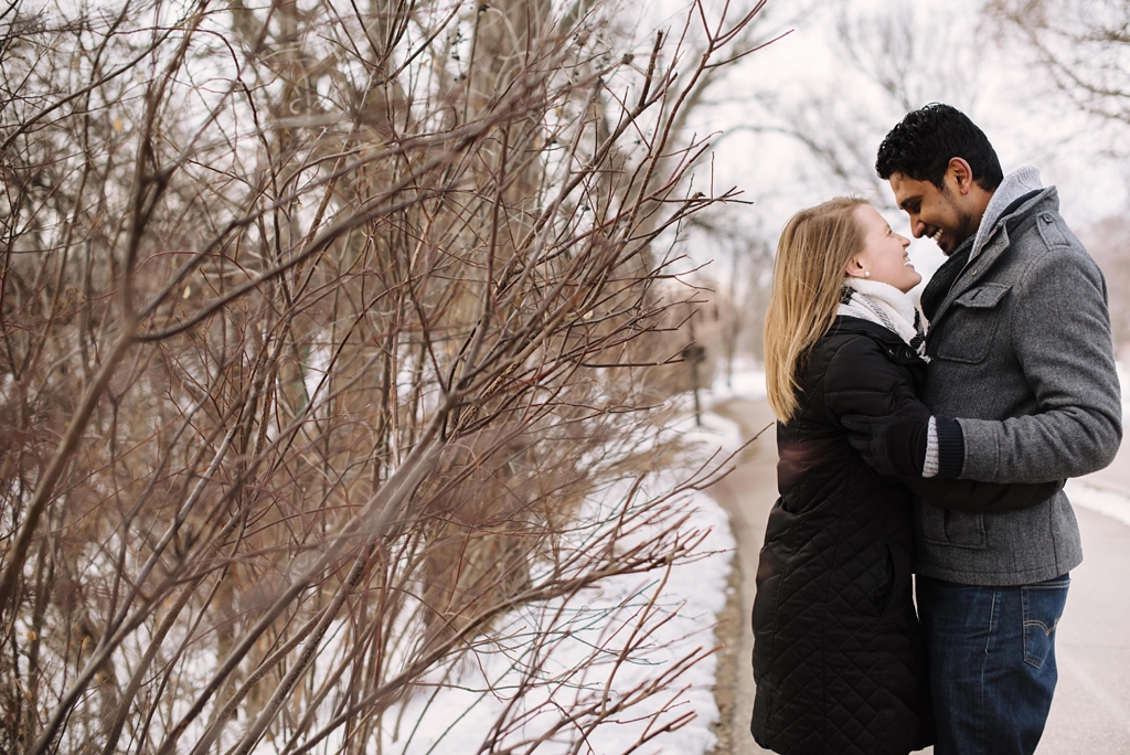 laughing couple in snow engagement session