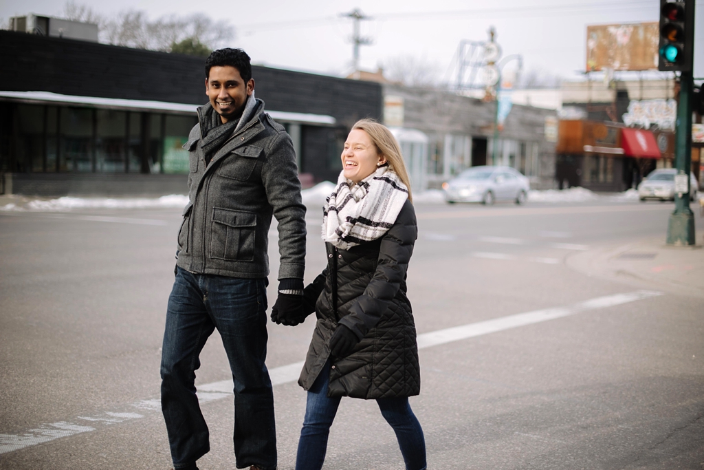 engagement session couple walks down minneapolis street