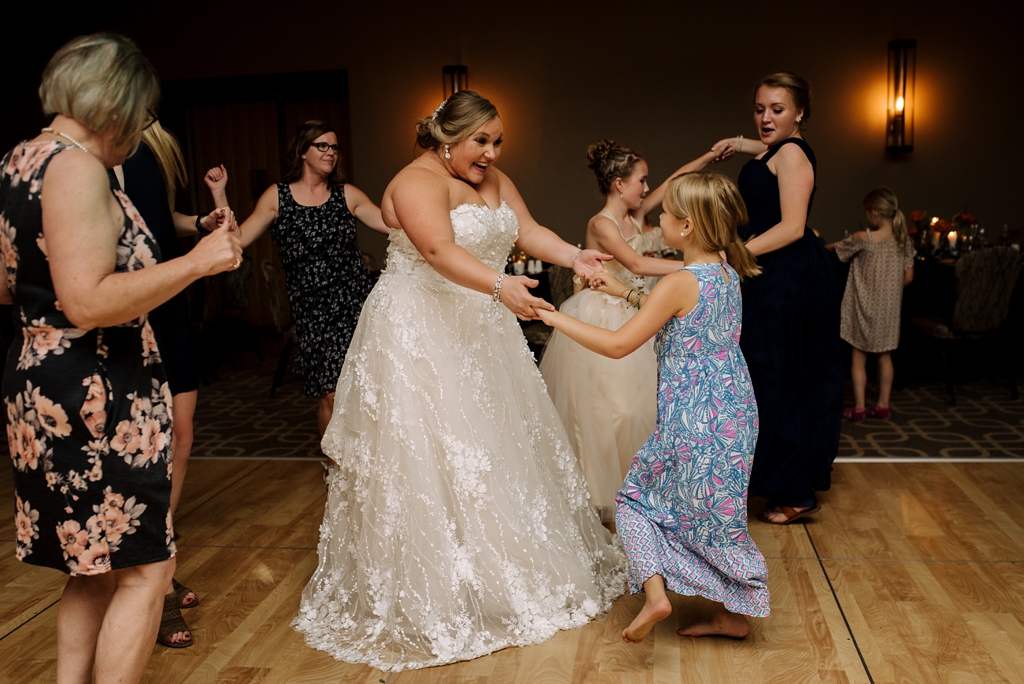 bride dancing with guests at wedding reception