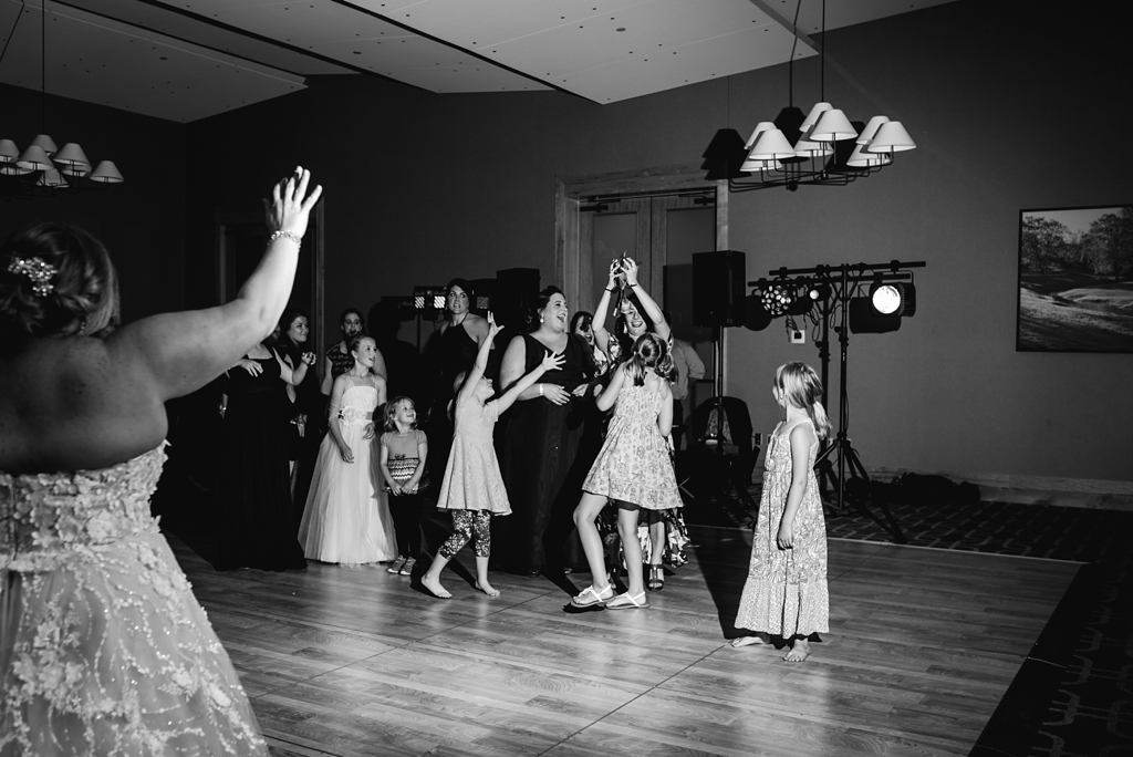 bridal bouquet toss in black and white