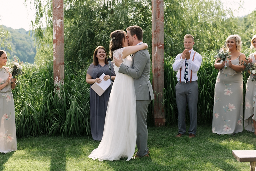 bride and groom kissing at outdoor ceremony