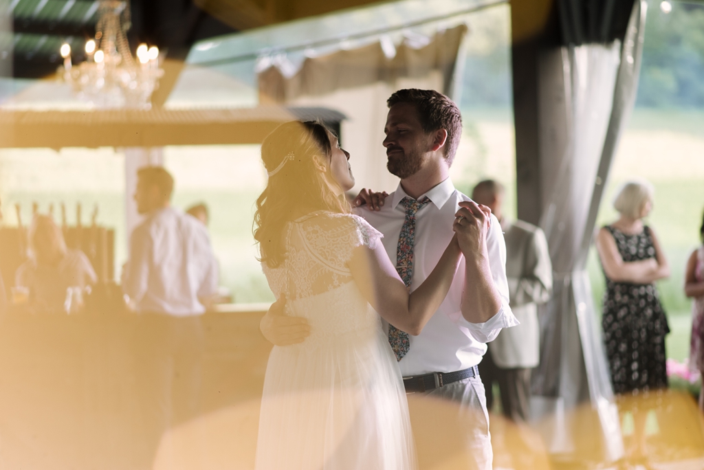 bride and groom dancing with yellow lens flare