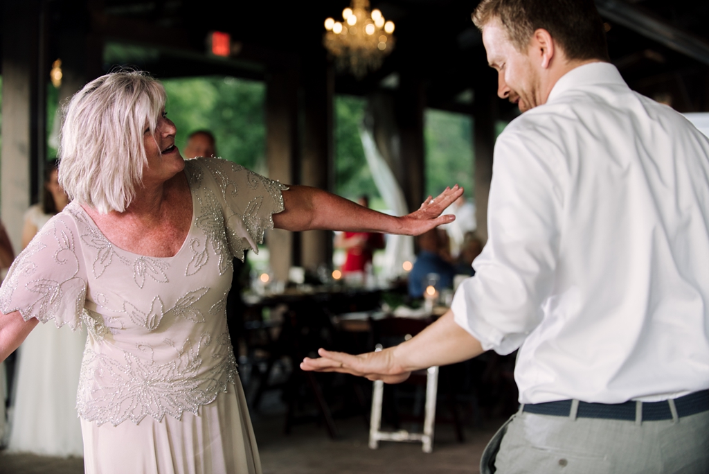 groom and mother dancing at farm wedding reception