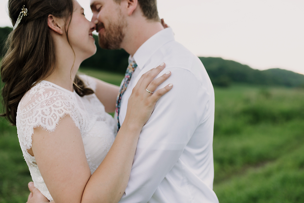 bride and groom almost kissing in wisconsin field